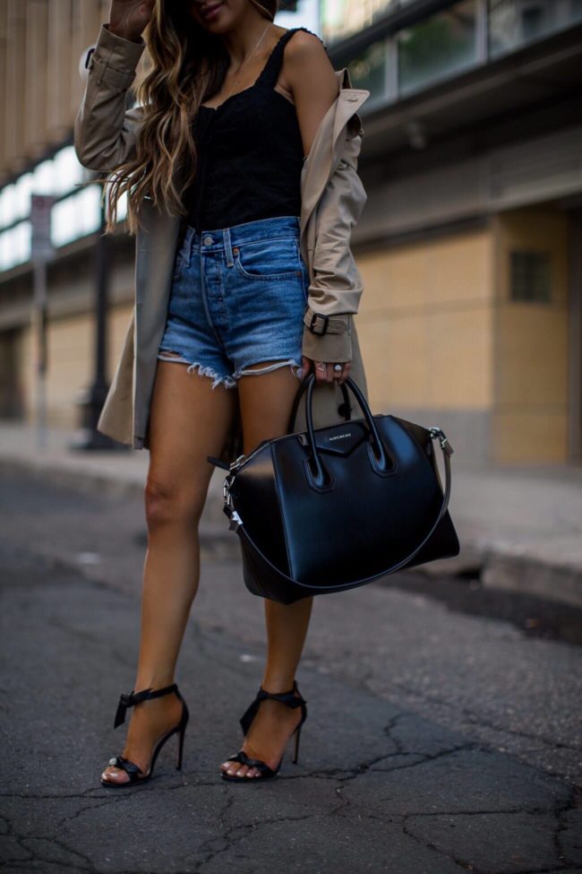 fashion blogger mia mia mine wearing levi's denim shorts and a givenchy bag