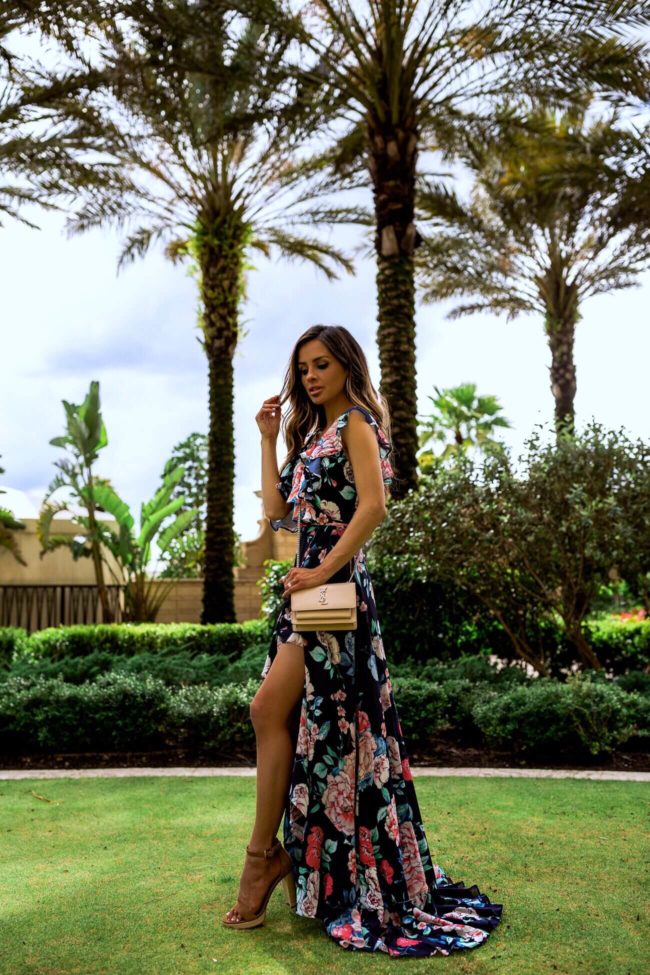 fashion blogger mia mia mine wearing a floral maxi dress at the four seasons orlando