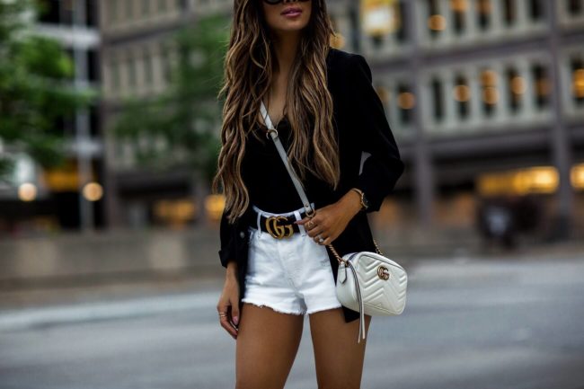 fashion blogger mia mia mine wearing white levi's shorts and a gucci belt