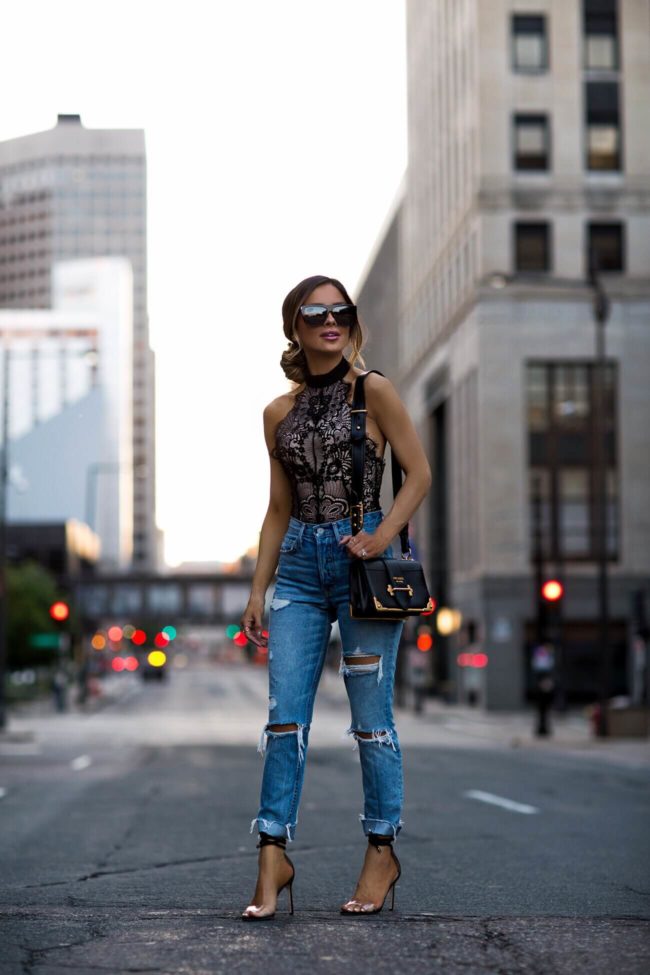 fashion blogger mia mia mine wearing a lace bodysuit from revolve and grlfrnd denim