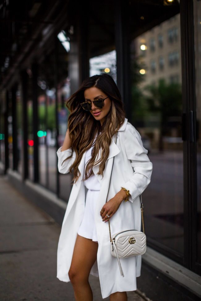 fashion blogger mia mia mine wearing a white romper from club monaco and a white trench coat