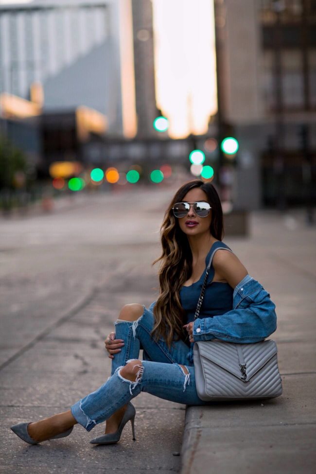 fashion blogger mia mia mine wearing a denim on denim outfit from revolve