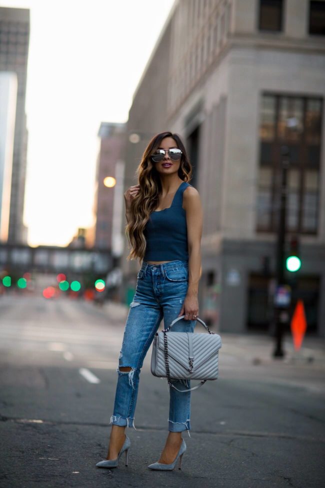 fashion blogger mia mia mine wearing a saint laurent college bag and a blue sweater crop top