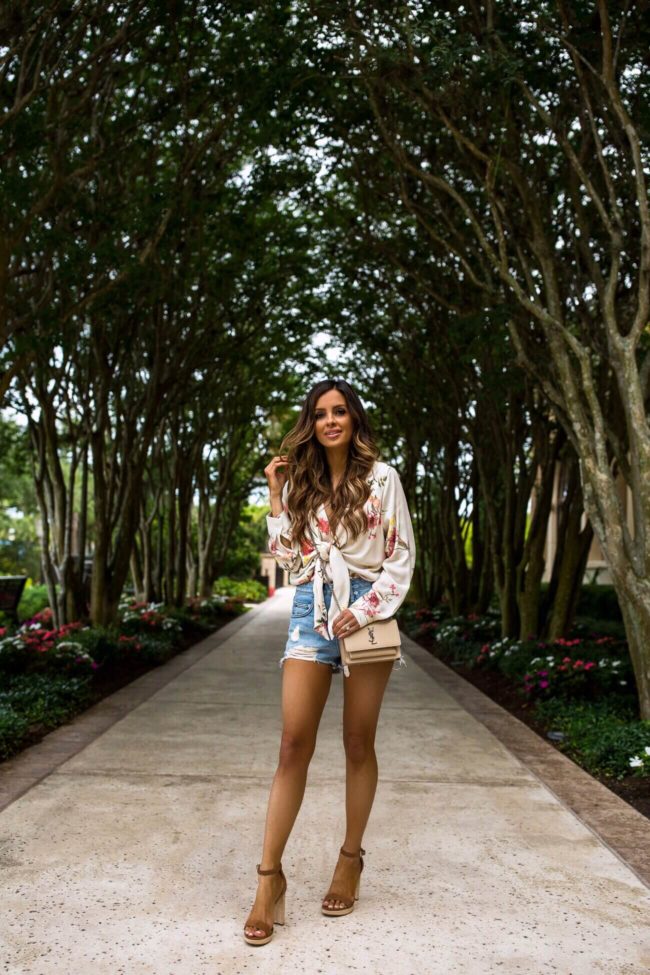 fashion blogger mia mia mine wearing lovers + friends denim shorts from revolve