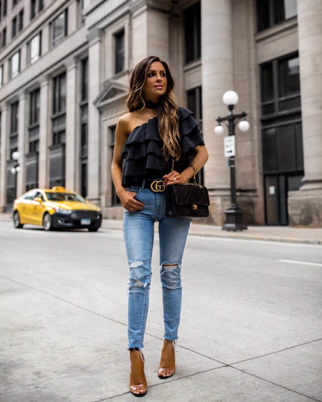 fashion blogger mia mia mine wearing an off-the-shoulder black ruffle top by parker smith