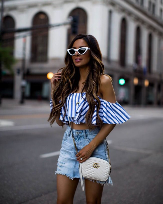 fashion blogger mia mia mine wearing a striped crop top and a denim one teaspoon skirt from shopbop