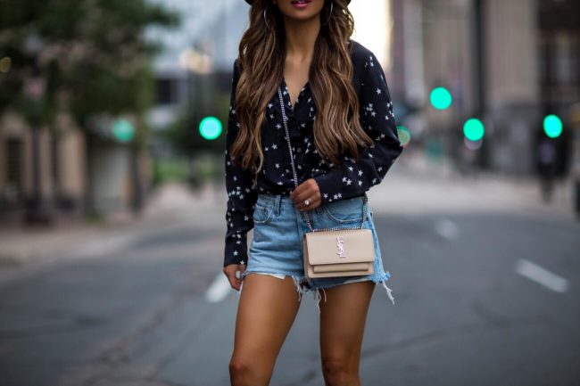 fashion blogger mia mia mine wearing a saint laurent sunset crossbody bag and levi's denim shorts