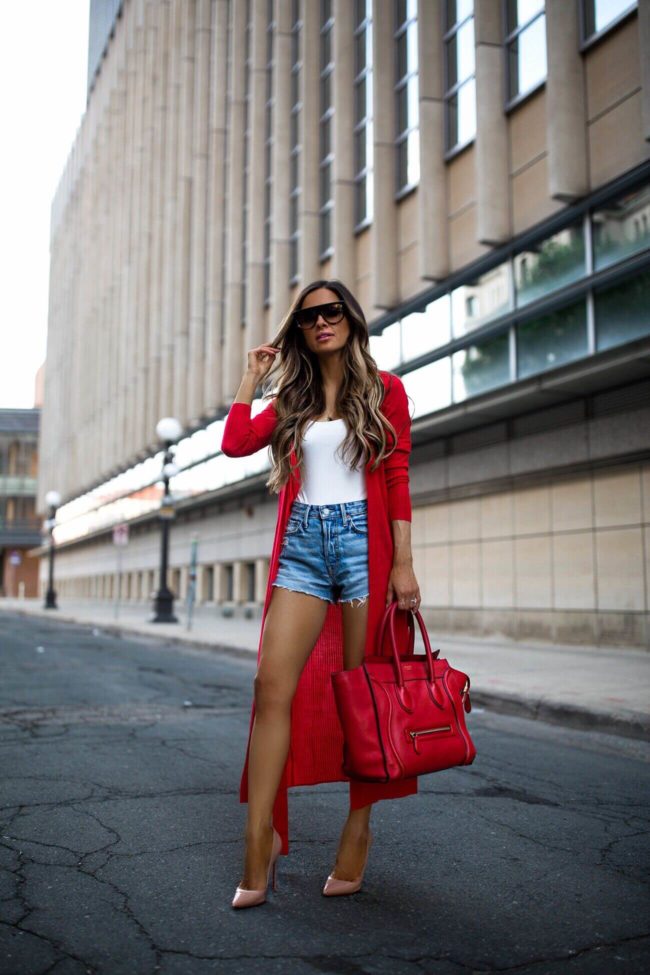fashion blogger mia mia mine wearing a red duster sweater and a red celine luggage tote