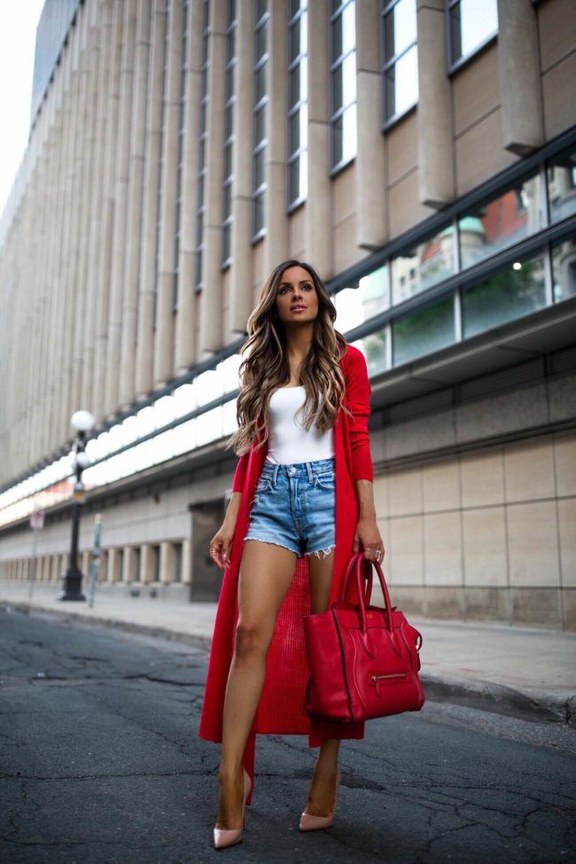 fashion blogger wearing a red duster sweater and grlfrnd denim shorts