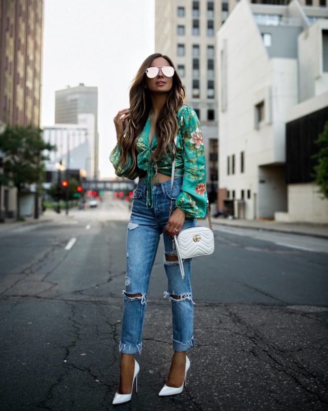 fashion blogger mia mia mine wearing a floral print crop top and grlfrnd denim from revolve