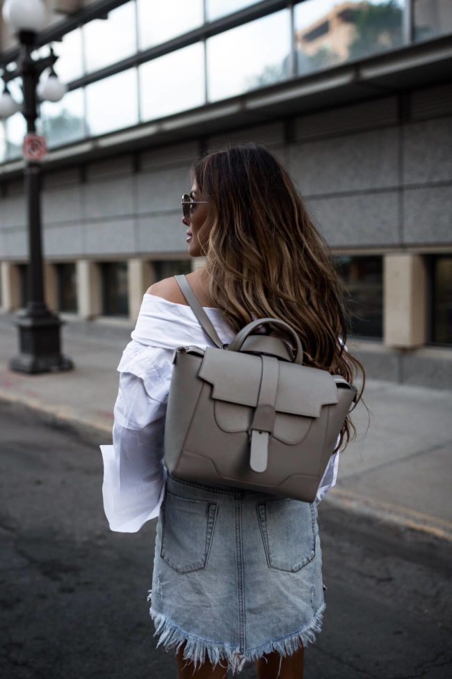 fashion blogger wearing a senreve work bag as a backpack