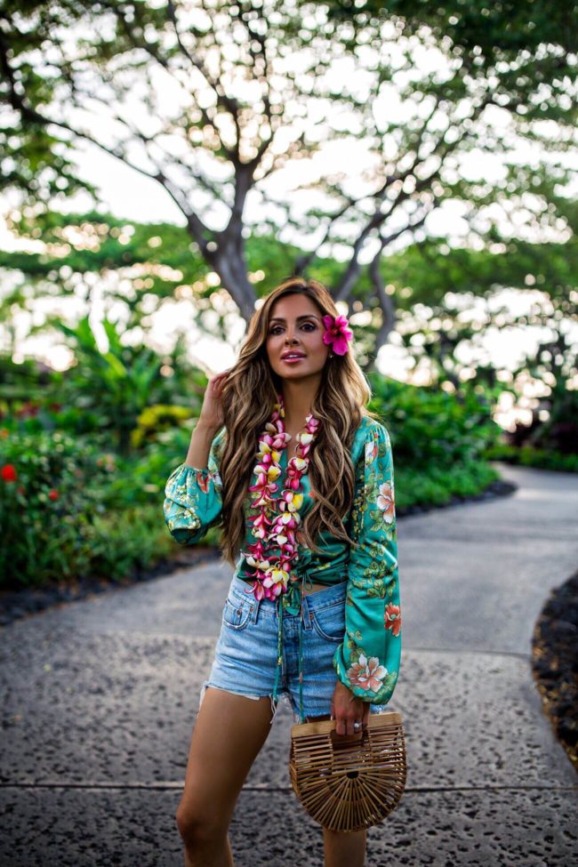 fashion blogger mia mia mine wearing a floral print top and denim shorts