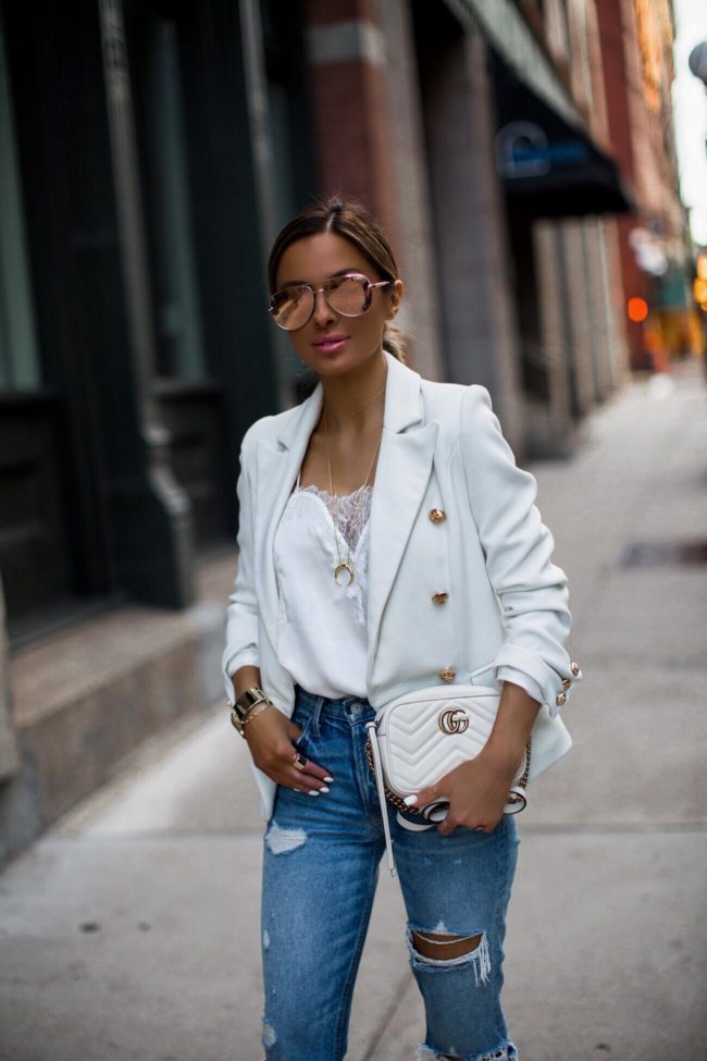fashion blogger mia mia mine wearing a white lioness blazer from shopbop