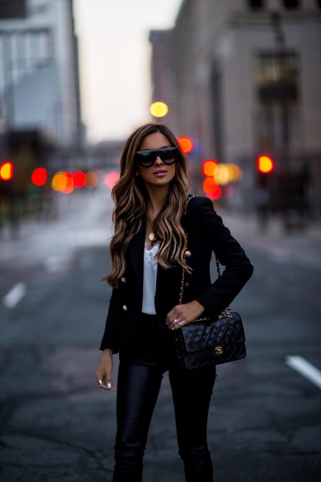 fashion blogger mia mia mine wearing a double flap chanel bag and celine sunglasses with a black blazer