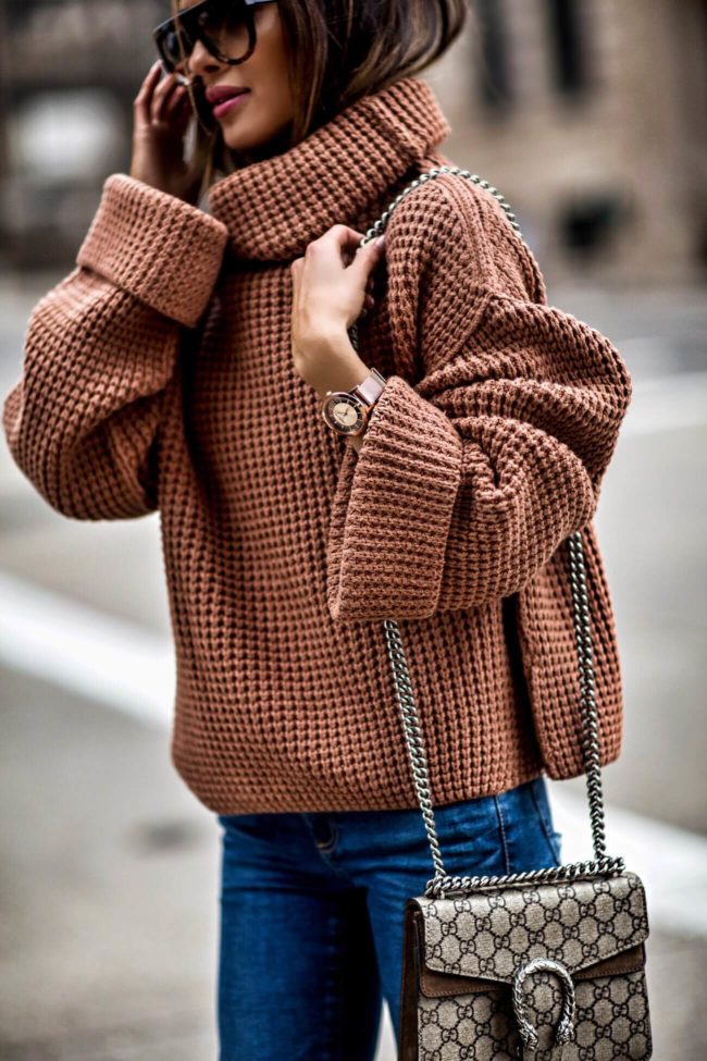 fashion blogger mia mia mine wearing an orange chunky sweater by free people