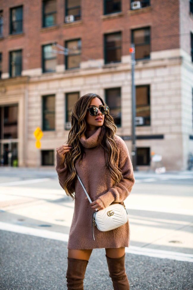 fashion blogger mia mia mine wearing a camel sweater dress and a gucci marmont white bag