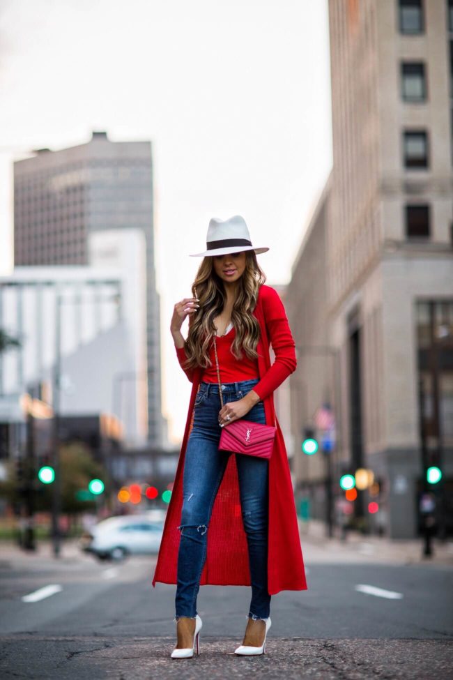 fashion blogger mia mia mine wearing a white panama hat by rag & bone and a red duster cardigan from revolve