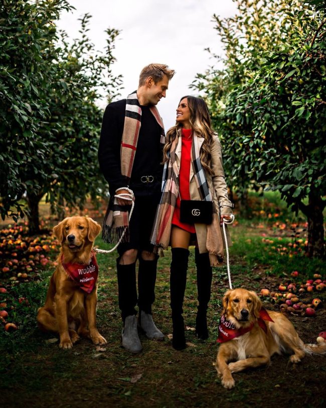 fashion blogger mia mia mine with husband and golden retrievers at aamodts apple orchard in stillwater minnesota