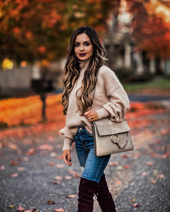 fashion blogger mia mia mine wearing a turtleneck sweater and chloe faye bag