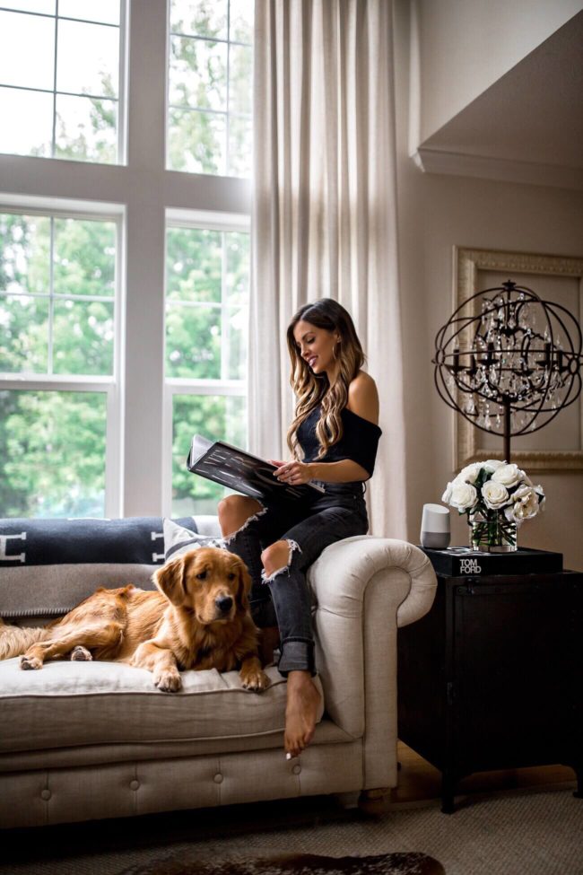 fashion blogger mia mia mine in her living room with golden retriever