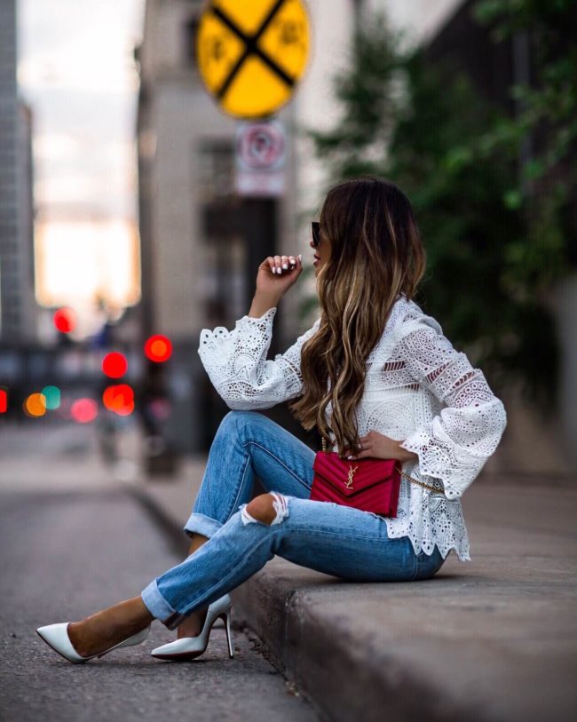 fashion blogger mia mia mine wearing a white lace top from asos and levi's denim with a saint laurent red bag