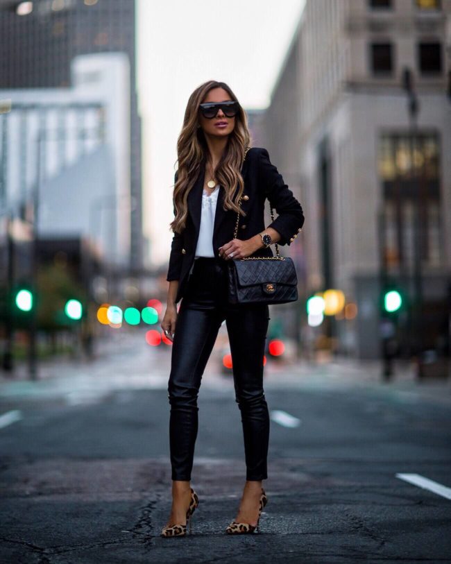 fashion blogger mia mia mine wearing a black blazer and faux leather pants with a chanel double flap bag