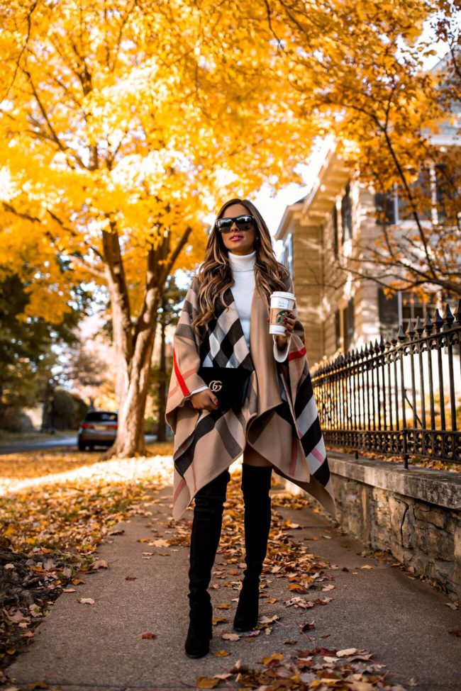 fashion blogger mia mia mine wearing a burberry cape and stuart weitzman over-the-knee boots from nordstrom