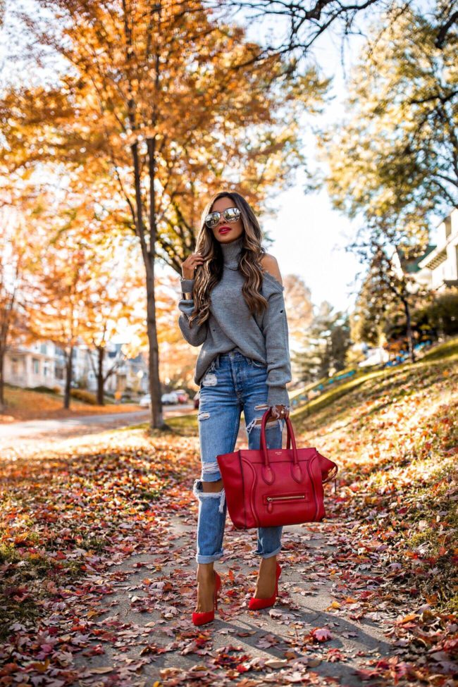 fashion blogger mia mia mine wearing a chunky turtleneck sweater from revolve and red christian louboutin eloise pumps