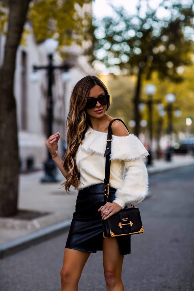 fashion blogger mia mia mine wearing a faux leather skirt and a prada cahier bag