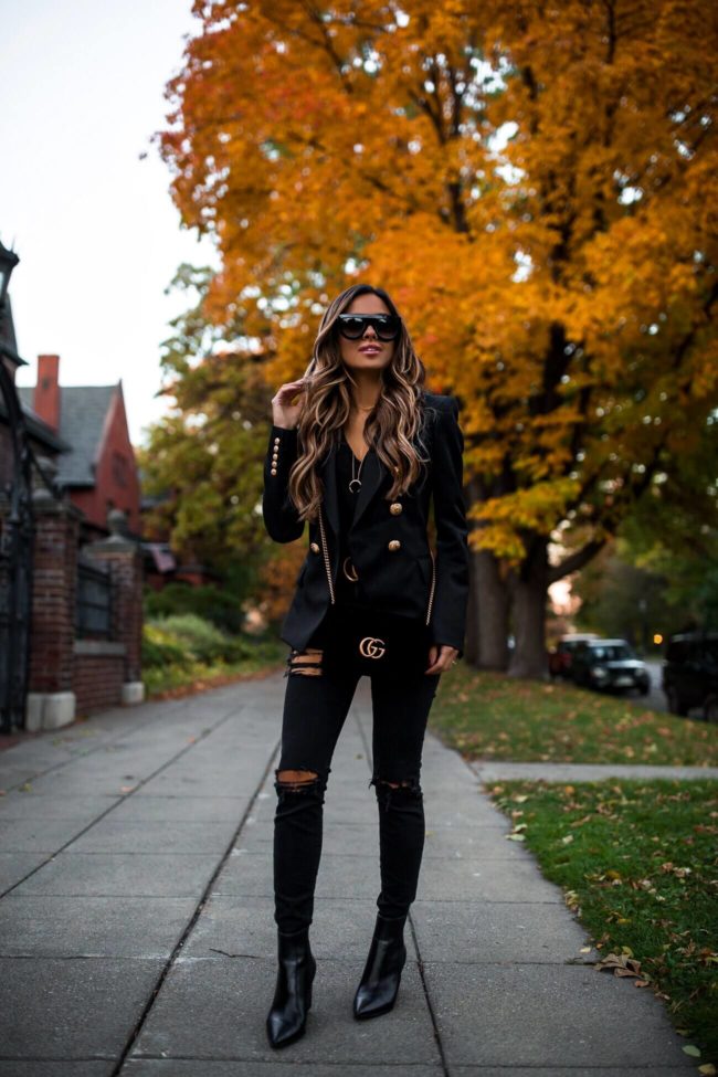 fashion blogger mia mia mine wearing an all black outfit with a gucci belt and gucci bag from nordstrom