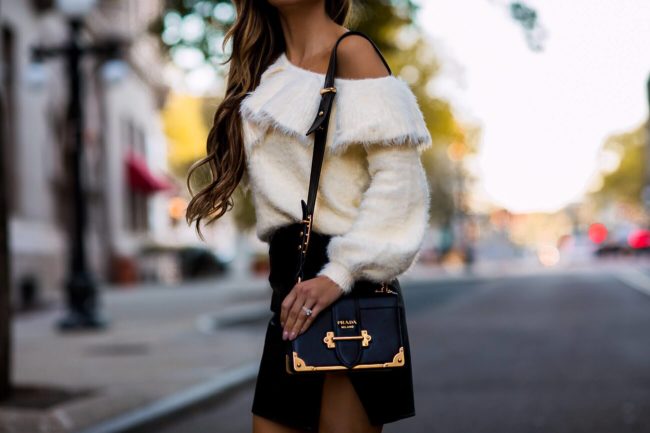 fashion blogger mia mia mine wearing a fuzzy sweater from revolve and a faux leather skirt