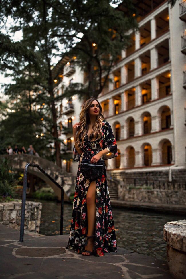fashion blogger mia mia mine wearing a floral dress to a fall wedding