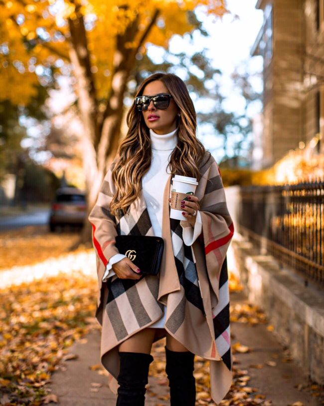 fashion blogger mia mia mine wearing a burberry poncho and a white sweater dress with a gucci velvet marmont bag for fall 2018