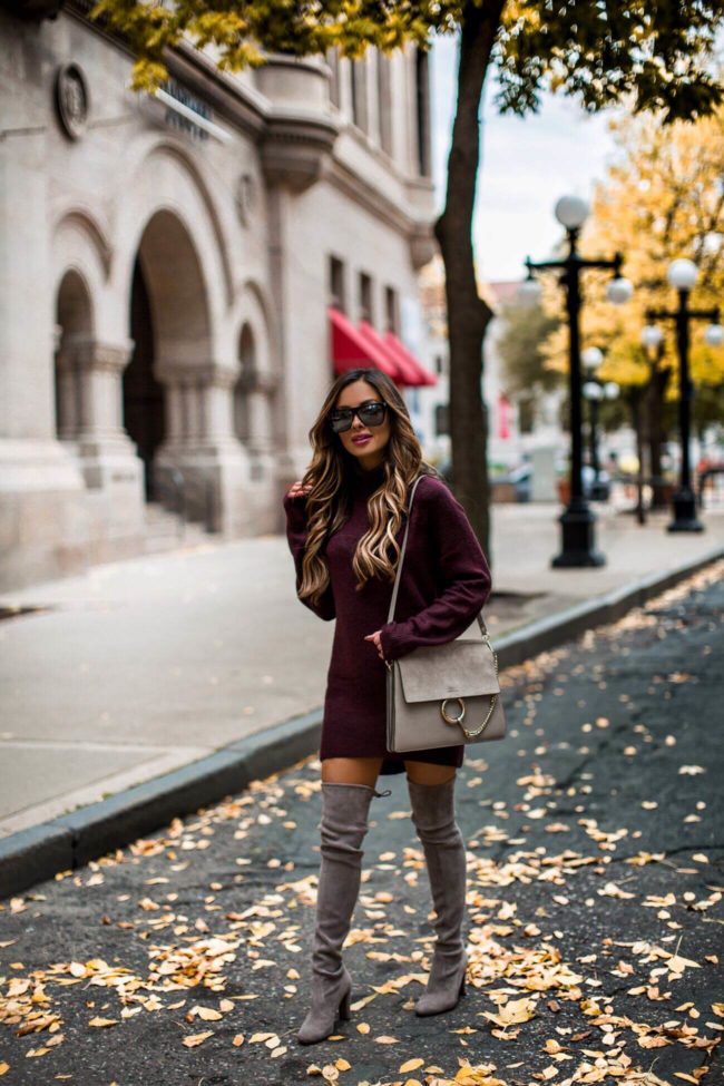 fashion blogger mia mia mine wearing a burgundy sweater dress from H&M and over-the-knee boots