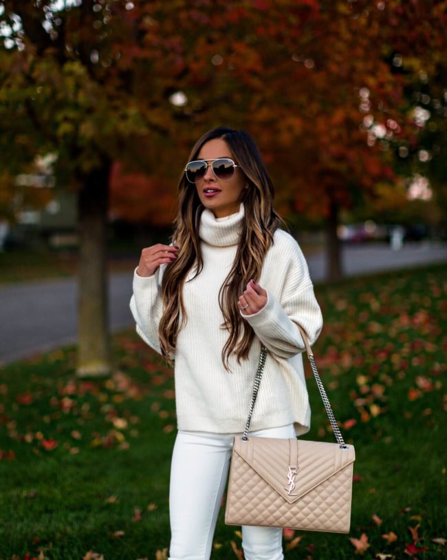 fashion blogger mia mia mine wearing a white sweater and saint laurent bag for fall 2018