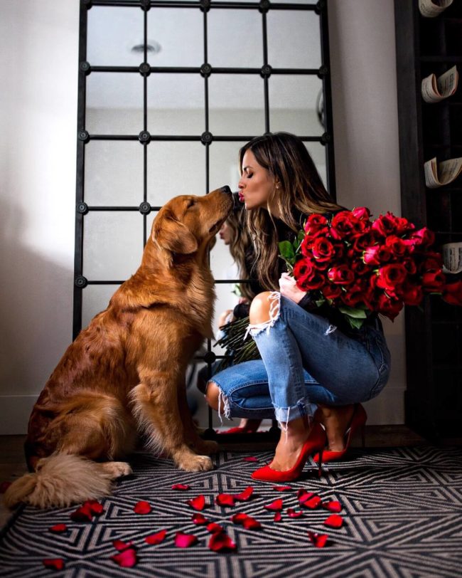 fashion blogger mia mia mine with golden retriever puppy and 100 roses