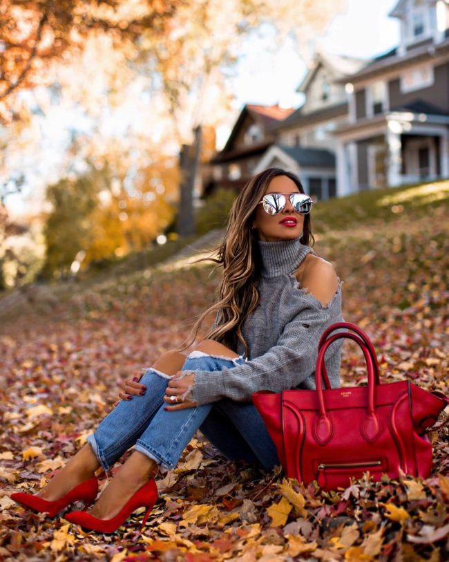 fashion blogger mia mia mine wearing a gray sweater and a red celine bag
