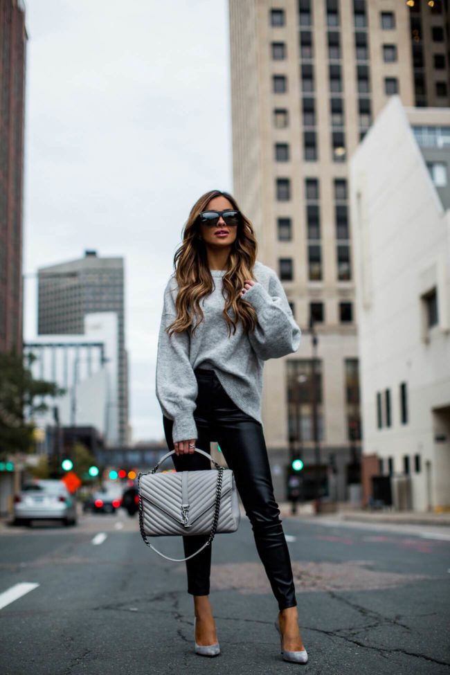 fashion blogger mia mia mine wearing a grey sweater and faux leather pants from shopbop