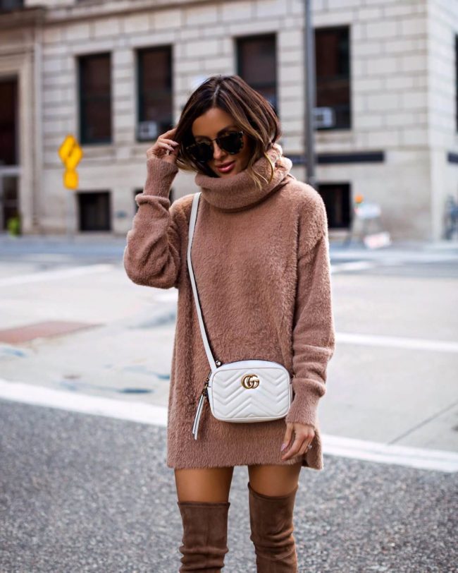 fashion blogger mia mia mine wearing a camel sweater dress and a gucci white marmont bag
