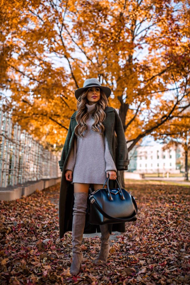 fashion blogger mia mia mine wearing a sweater dress by free people from nordstrom and a givenchy antigona bag with stuart weitzman over-the-knee boots