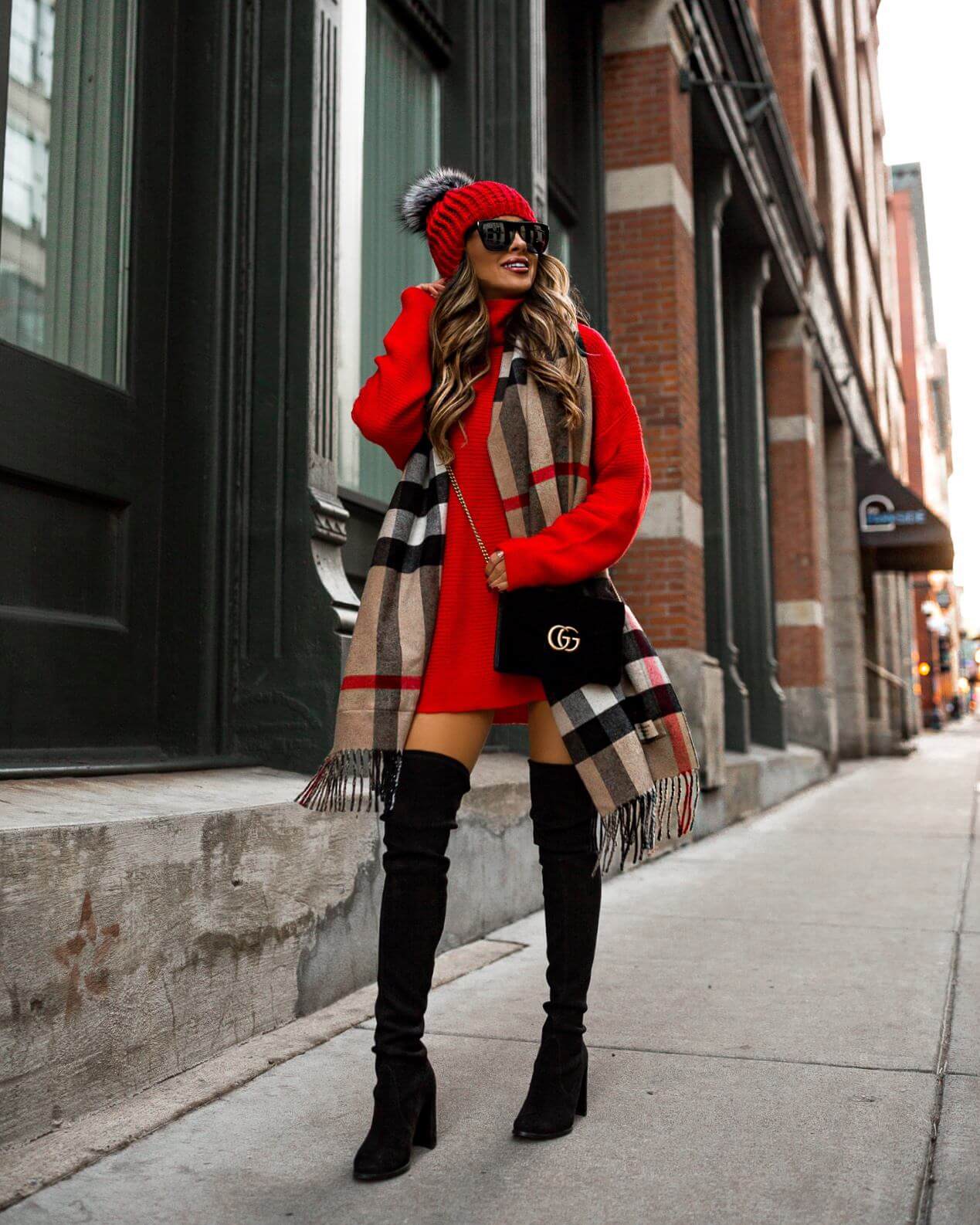 fashion blogger mia mia mine wearing a burberry scarf and a red sweater dress for holidays 2018