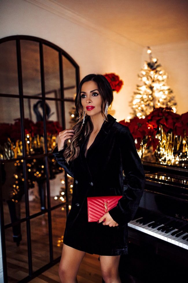 fashion blogger mia mia mine wearing a black velvet blazer and chandelier earrings for the holidays 2018