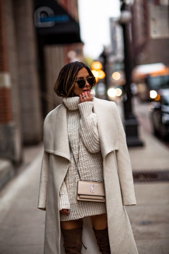 fashion blogger mia mia mine wearing a white winter coat and a white sweater dress from mango