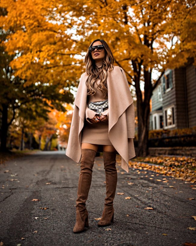 fashion blogger mia mia mine wearing a camel coat and over-the-knee stuart weitzman boots