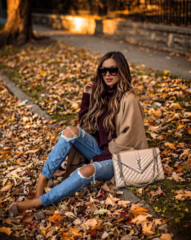 fashion blogger mia mia mine wearing a burberry poncho and grlfrnd denim for fall 2018