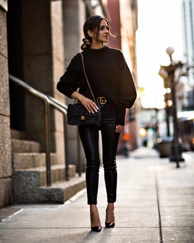 fashion blogger mia mia mine wearing a gucci belt and an all black outfit
