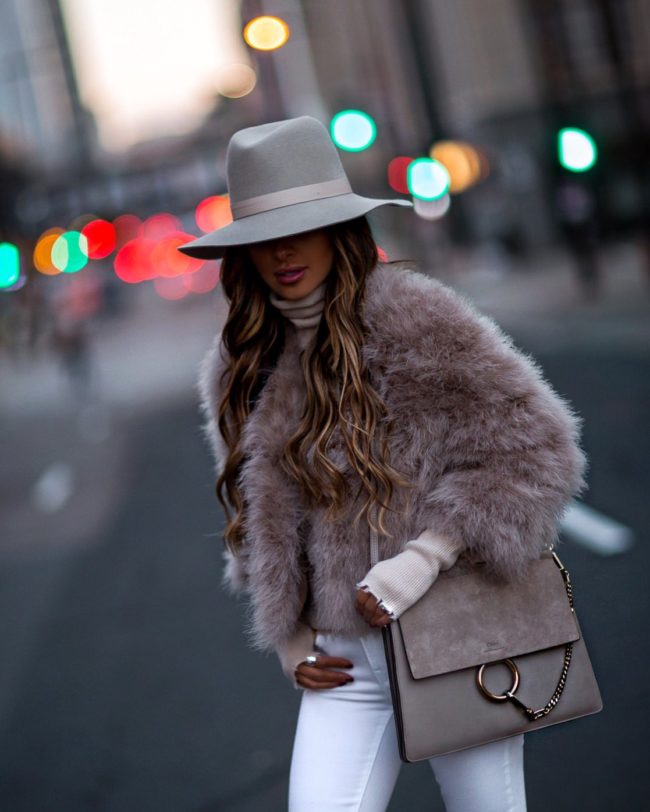 fashion blogger mia mia mine wearing a pink feather bolero jacket and a chloe faye bag on sale for black friday