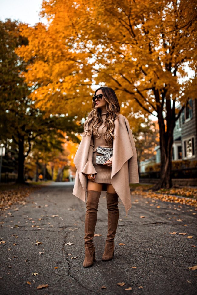 fashion blogger mia mia mine wearing a camel coat and sweater dress from revolve and a gucci marmont bag