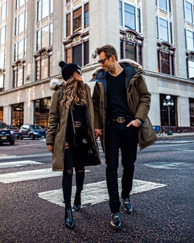 fashion blogger mia mia mine wearing a canada goose jacket and a gucci belt wtih husband phil