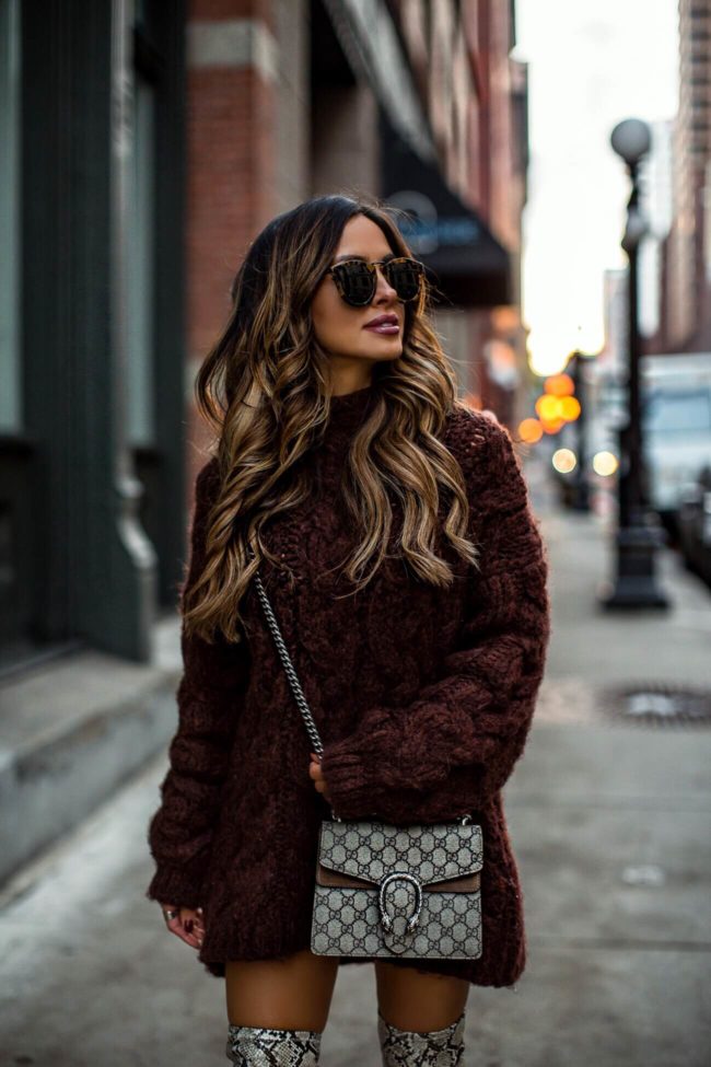 fashion blogger mia mia mine wearing a chunky brown sweater dress and a gucci dionysus bag